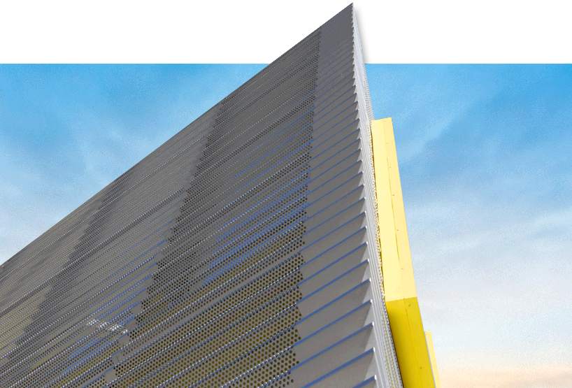 A parking garage covered in perforated metal cladding.