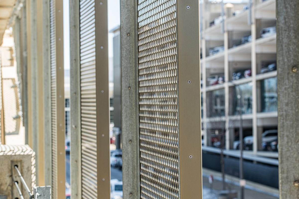 Looking at perforated metal from a parking Garage
