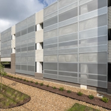 Multiple perforated metal panels on a parking garage