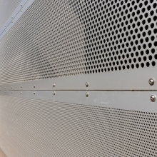 Close up of perforated metal on a parking garage, exterior